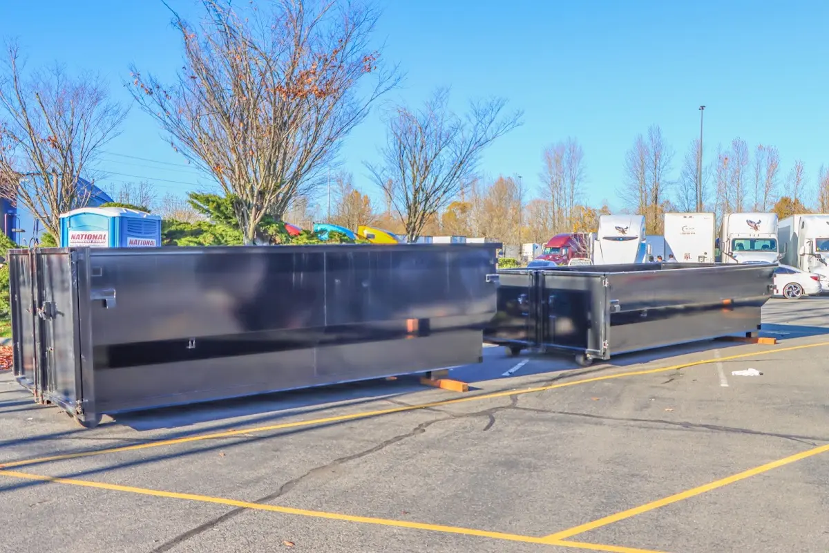 Professional dumpster rental service with roll-off container on residential driveway in Discovery Bay